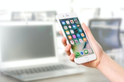 White iPhone in a person's hand